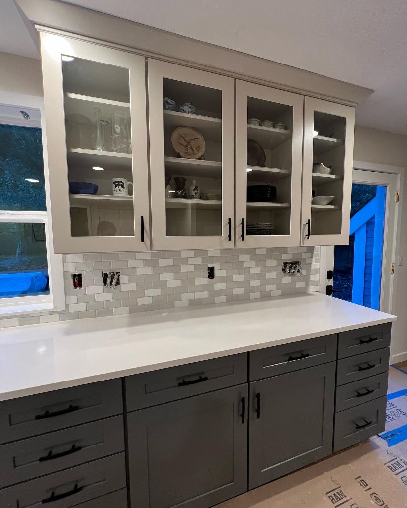 Two-tone cabinetry with glass uppers