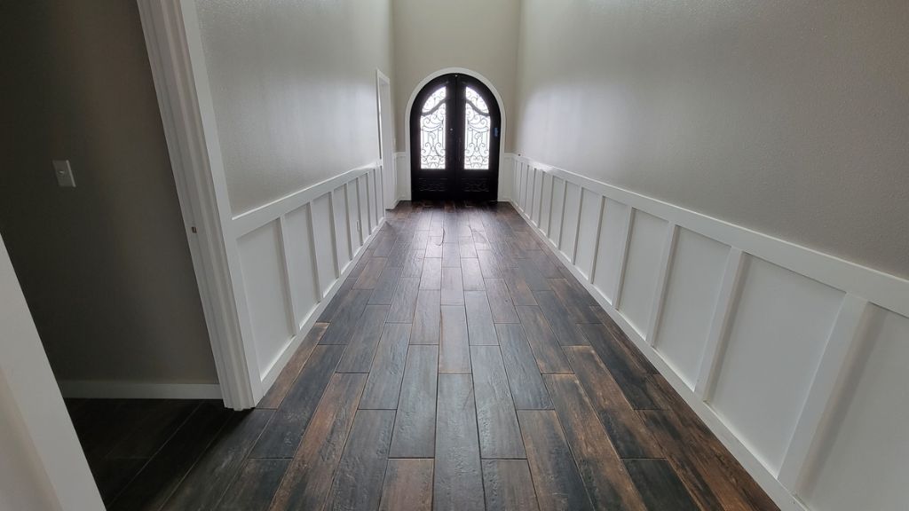 Grand entryway with dark wood plank tile flooring
