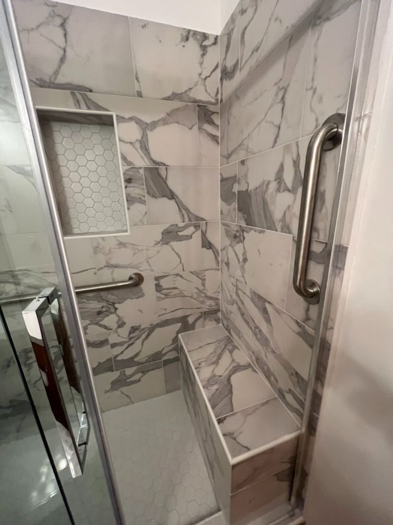 Marble walk-in shower with bench